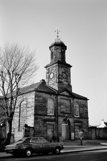 A historic stone church with a central spire. Reference no: SC_584476