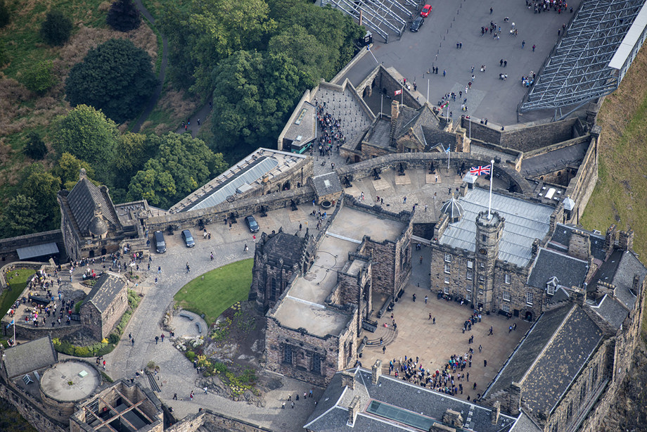 Many large stone buildings making up Edinburgh Castle, and a small stone chapel building as part of the complex