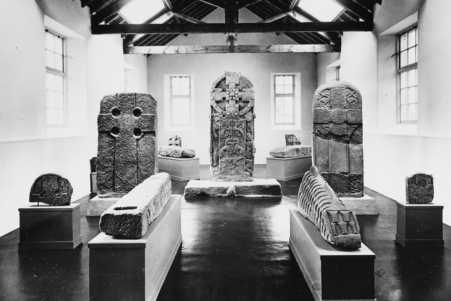 Several large, carved historic stones on display in a museum