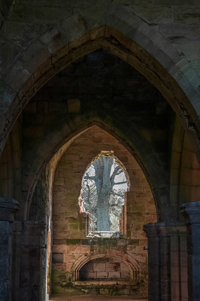 Stone archways, leading towards a window
