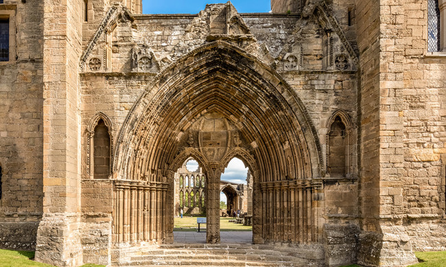 A decoratively carved, arched, stone entrance