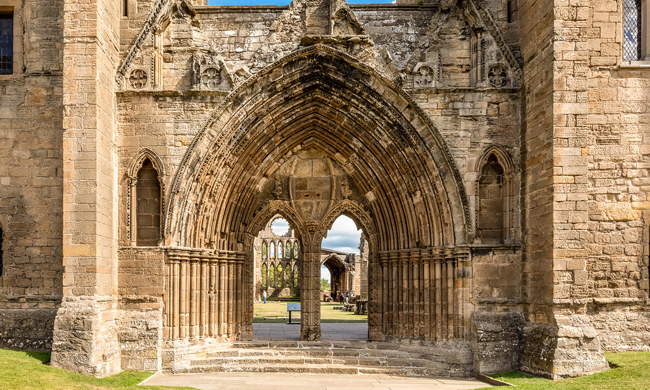 A decoratively carved, arched, stone entrance
