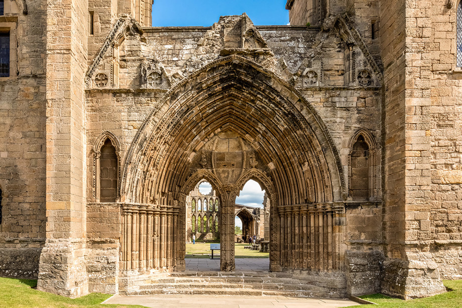 A decoratively carved, arched, stone entrance