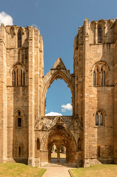 A tall, stone cathedral made up of two pillars joined by an entranceway and archway