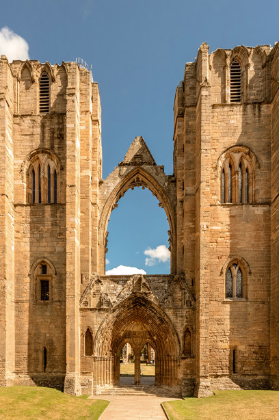 A tall, stone cathedral made up of two pillars joined by an entranceway and archway