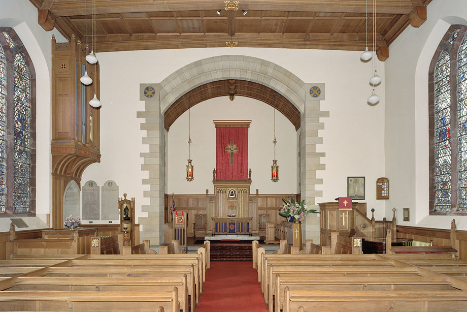 A chapel with a wooden ceiling, and rows of wooden pews looking towards an altar. Reference no: SC_1017071 