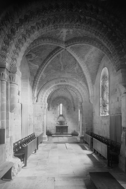 A long, narrow stone room with a vaulted ceiling