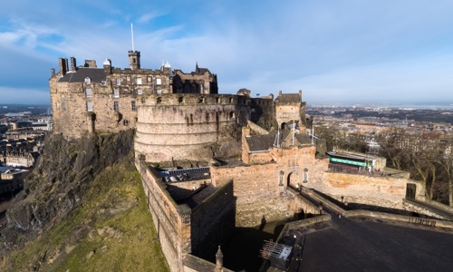 A photo of Edinburgh Castle with a backdrop of blue clear skies