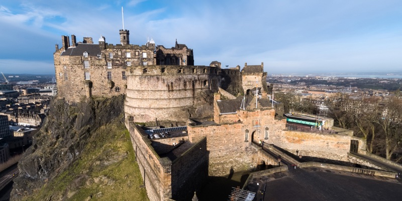 A photo of Edinburgh Castle with a backdrop of blue clear skies