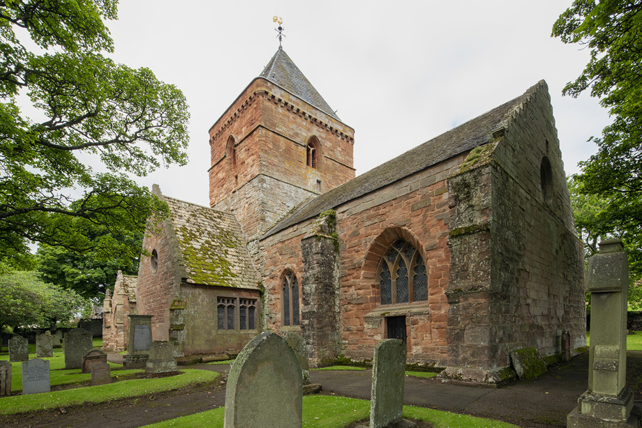 Exterior of a red stone church in Whitekirk. Image reference number: DP_377666 