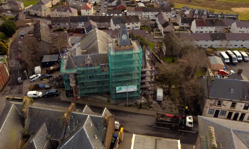 an areial view of the town hall at Maybole. The tower of the building (which may date to the 1500s) is surrounded in scaffolding for works.