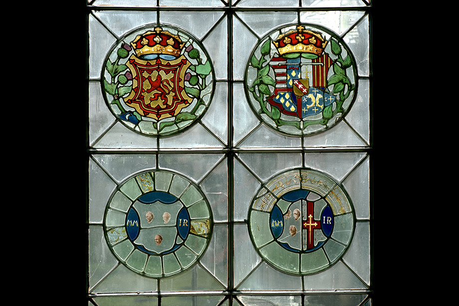 A stained glass window made up for four circular crests 