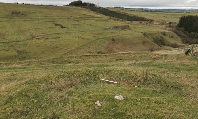 A view across isoaltyed moorland towards a surviving hut from a militray camp