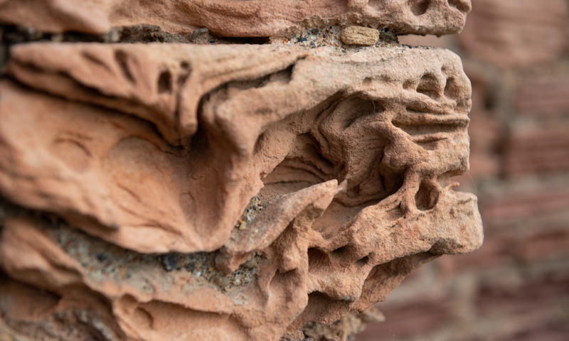 Close up of sandstone showing lots of patterns and holes from erosion.