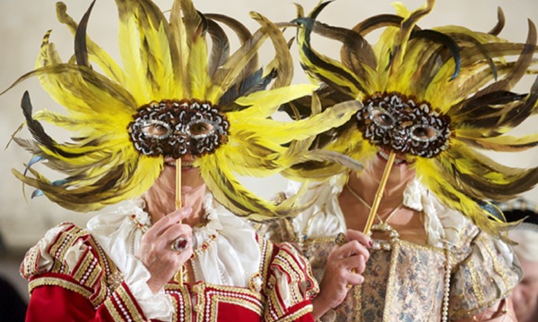A picture of two people in costume wearing masks