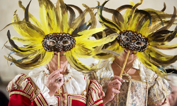 A picture of two people in costume wearing masks