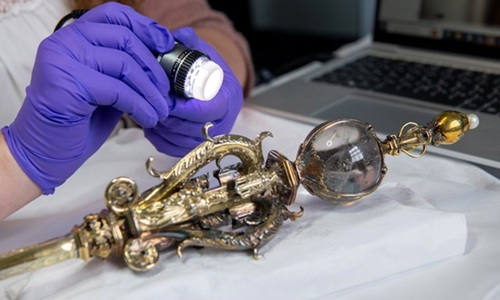 The Sceptre on a table being examined with a light