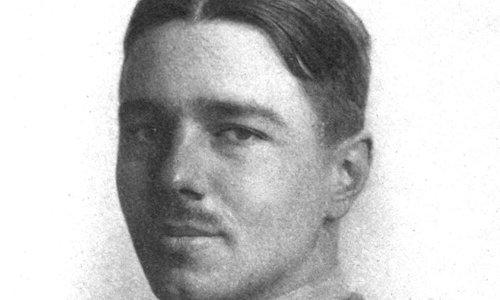 Black and white portrait photo of a person with a moustache in military uniform.