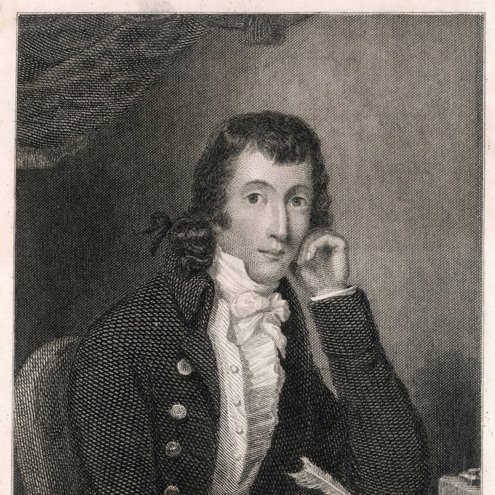 Black and white drawing of a person seated at a table writing a letter. They are using a quill pen and are looking at the camera, with their other hand resting against their face. They are wearing a jacket with many buttons and a frilled white shirt.