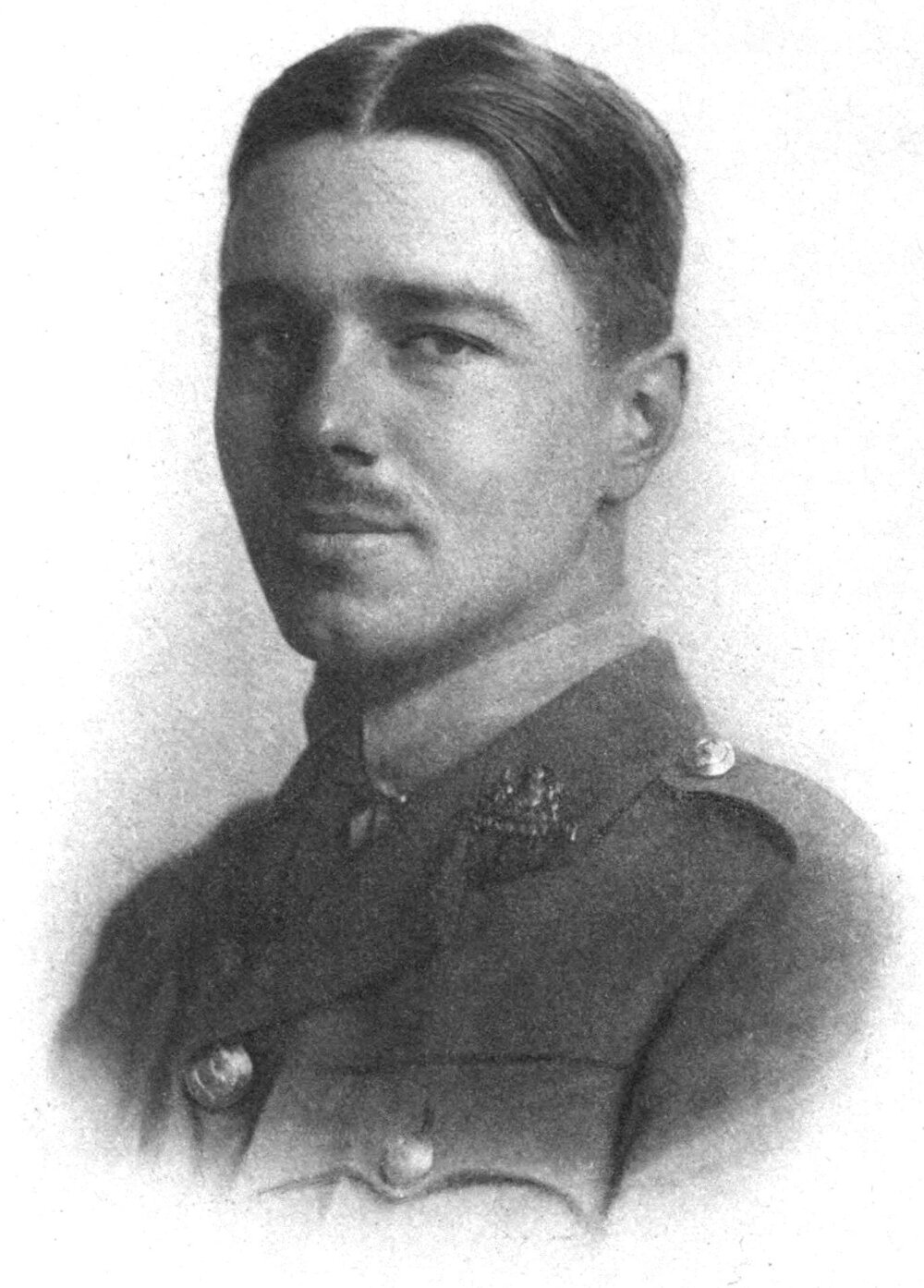 Black and white portrait photo of a person with a moustache in military uniform.