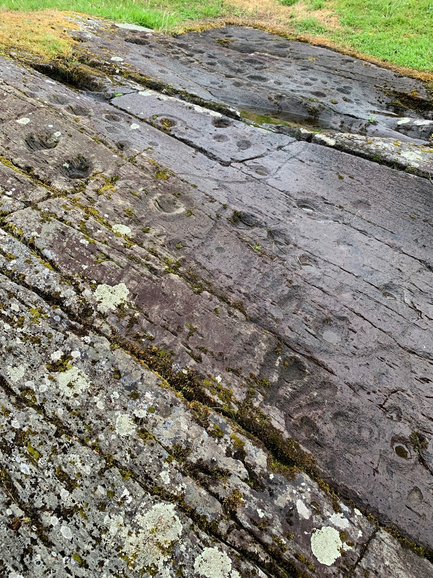 Stone surface with lines and cup marks