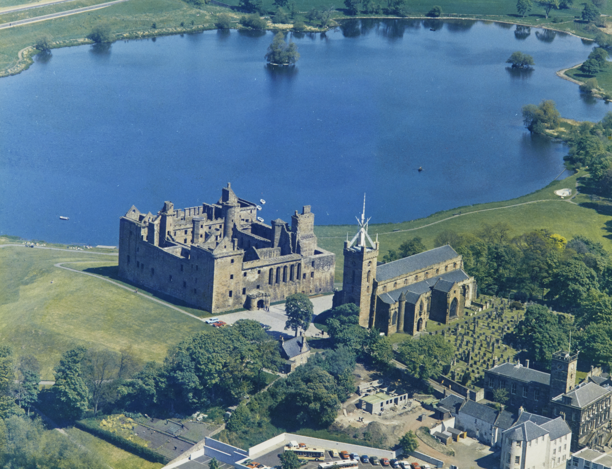Aerial view of Linlithgow Palace from above town with loch in background