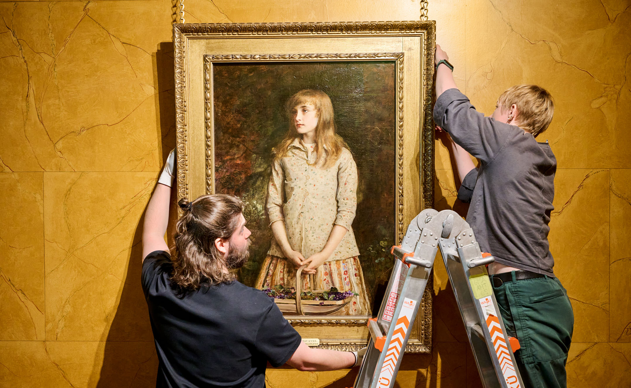 Two technicians hang painting 'Sweetest eyes were ever seen’ painting by Sir John Everett Millais (1829-1896) on a yellow wall