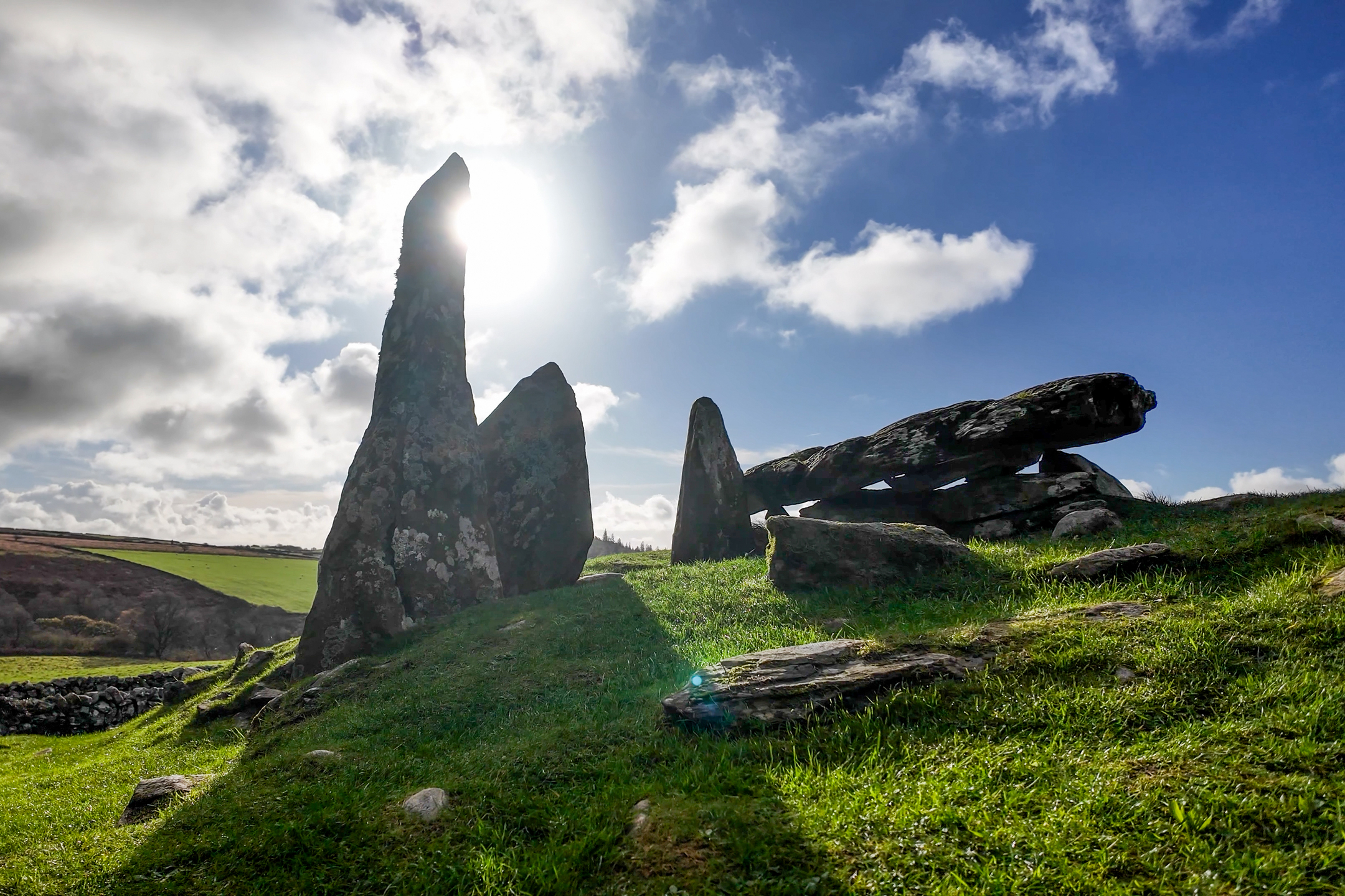 Landscape view of some ragged stones on a grassy meadow on a sunny day