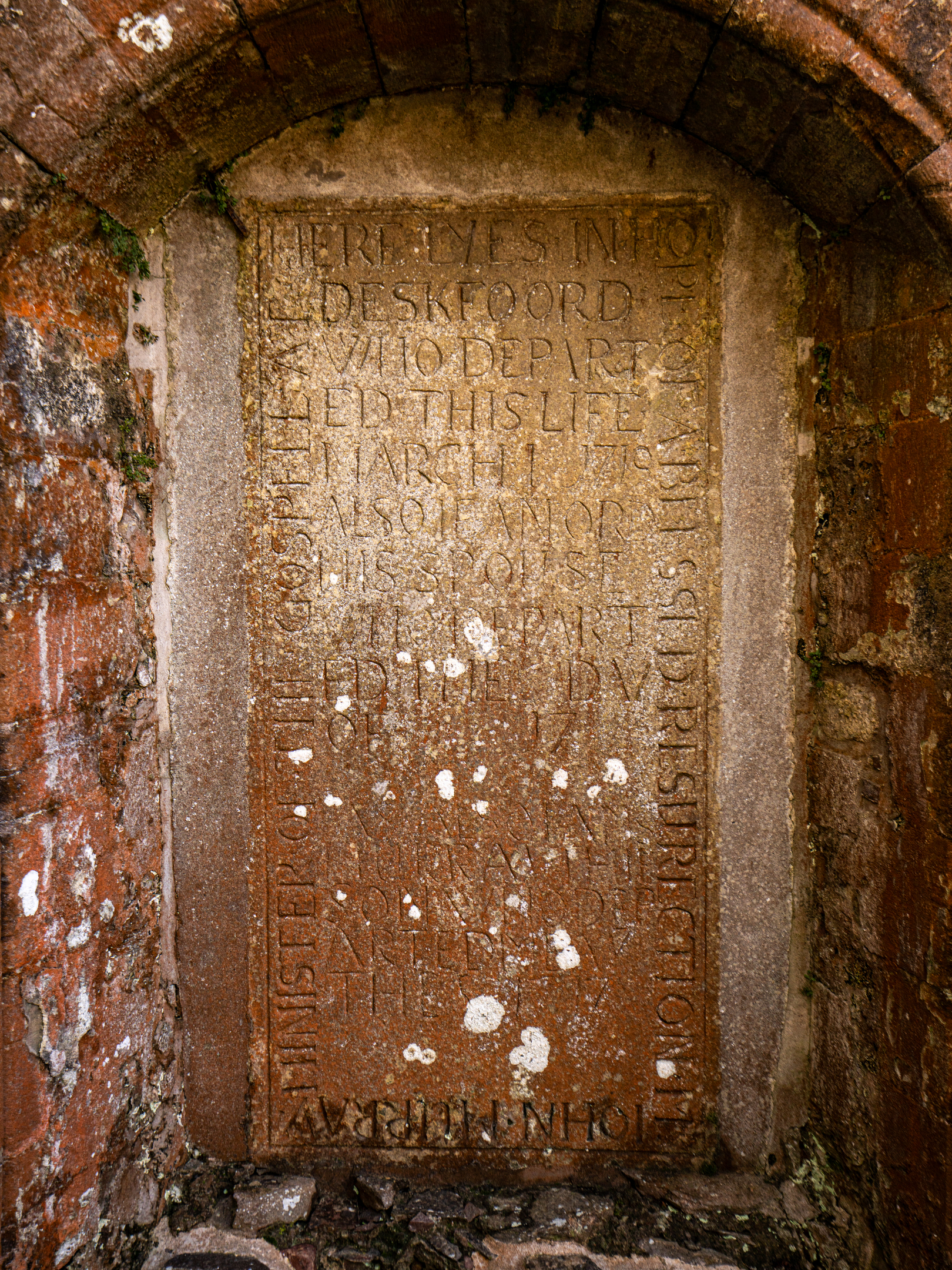 Gravestone with carved words in an enclave. 