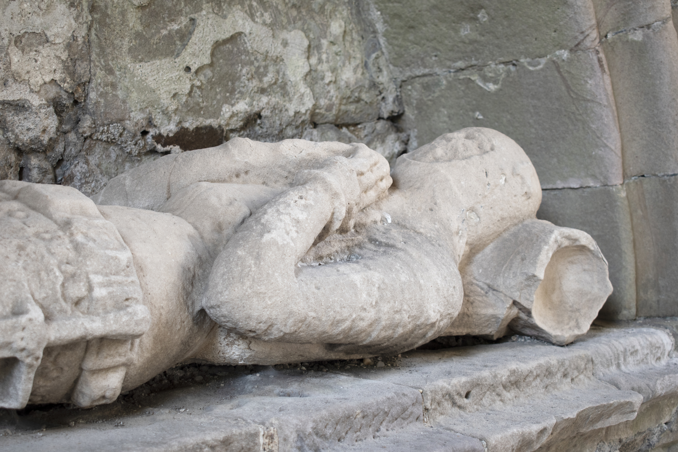 Head and torso of stone sculpture of knight lying down, part of tomb