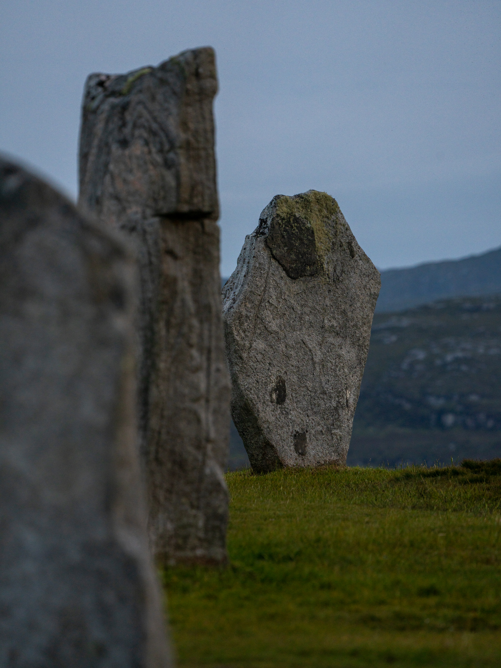Close view of a textured Calanais stone illuminated by soft morning light.