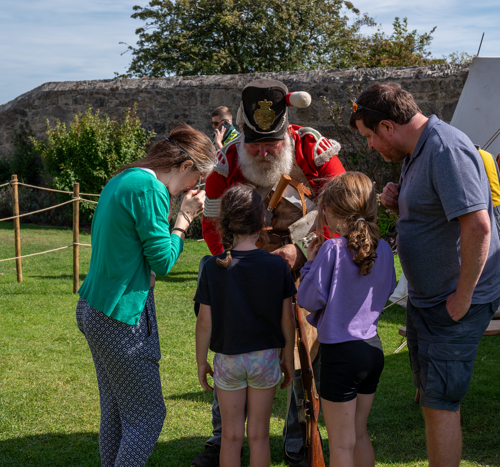 A costumed performer entertaining a family
