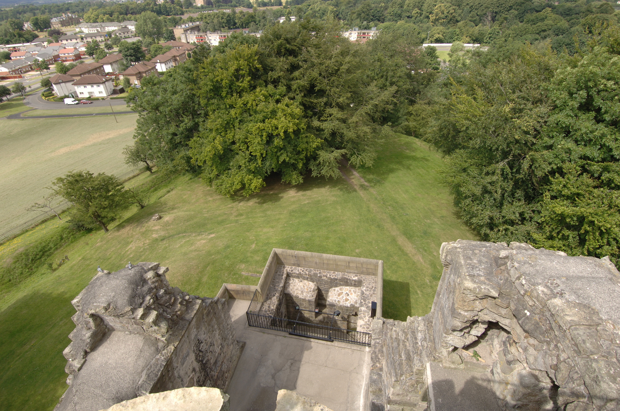 Angled view taken from a wall at Crookston Castle overlooking the surrounding landscape 