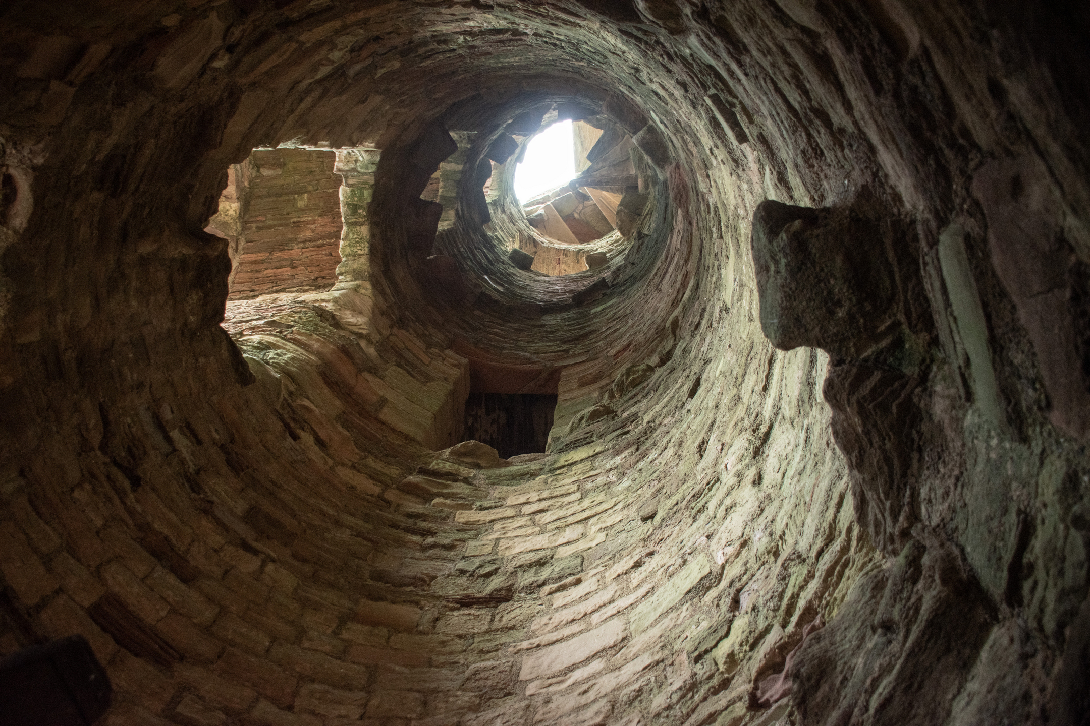 Interior view of castle ruin showing the view upwards where there once was a spiral staircase