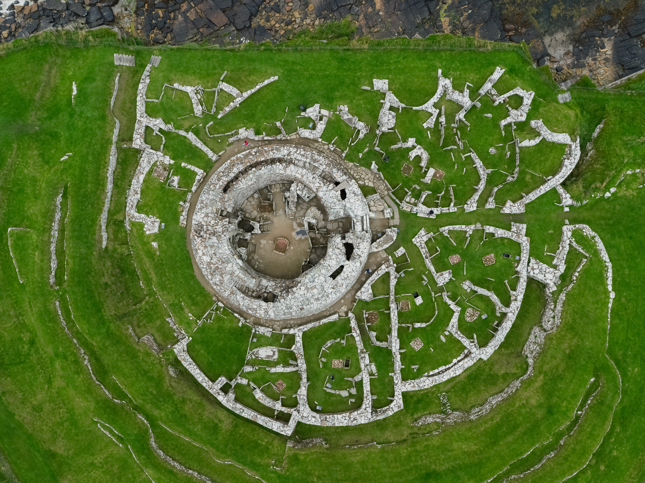 Neolithic circular stone structure in a grassy field