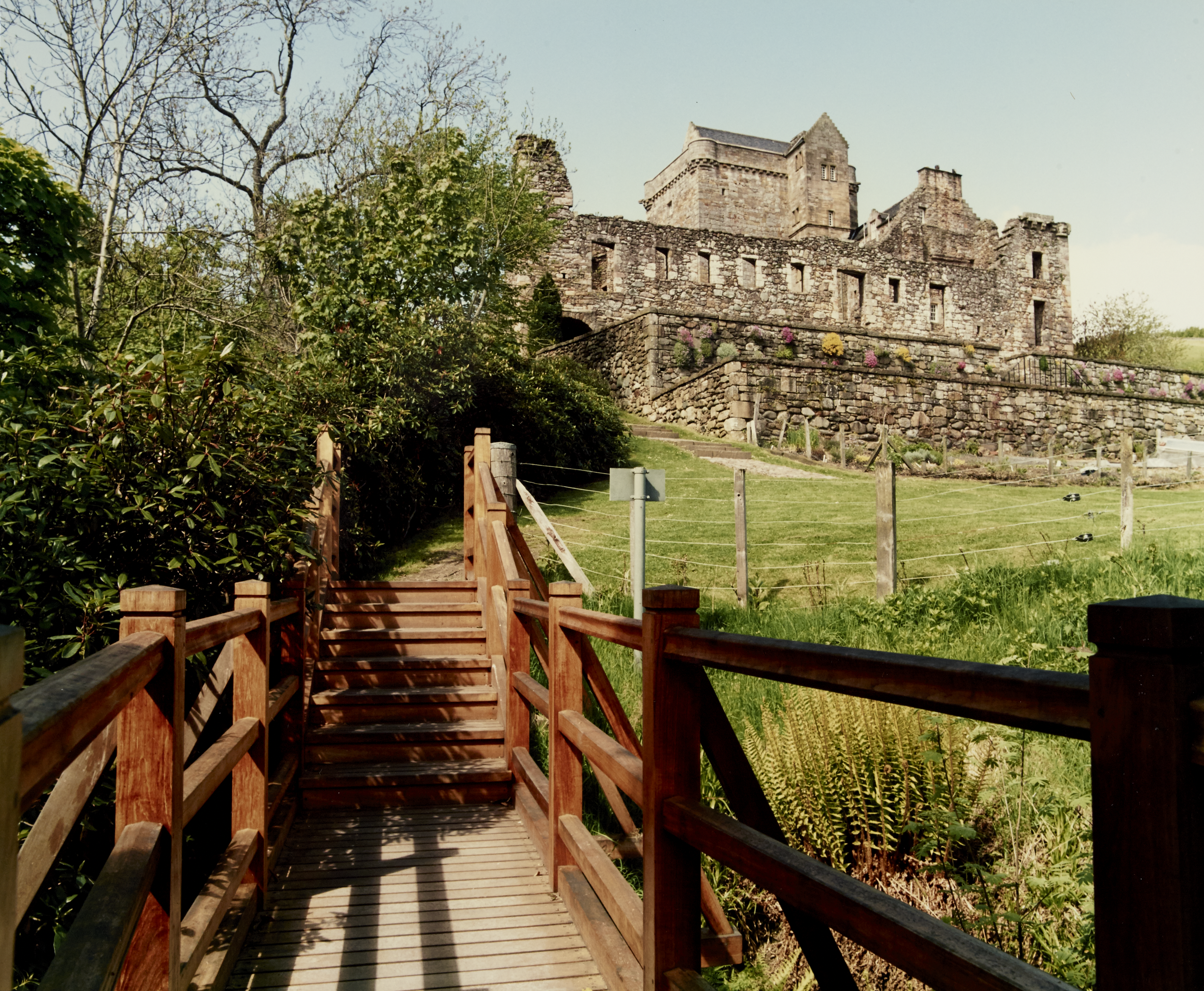Castle Campbell from a wooden bridge in the garden area beneath the castle