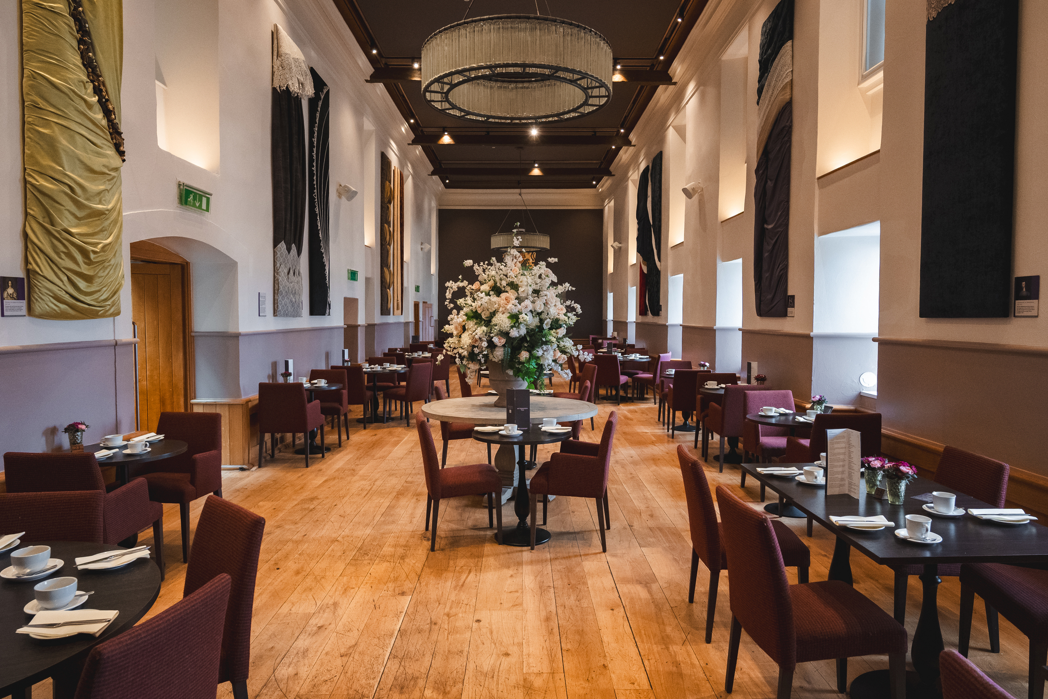 A café dining area at Edinburgh Castle with a large bouquet of flowers at the centre.