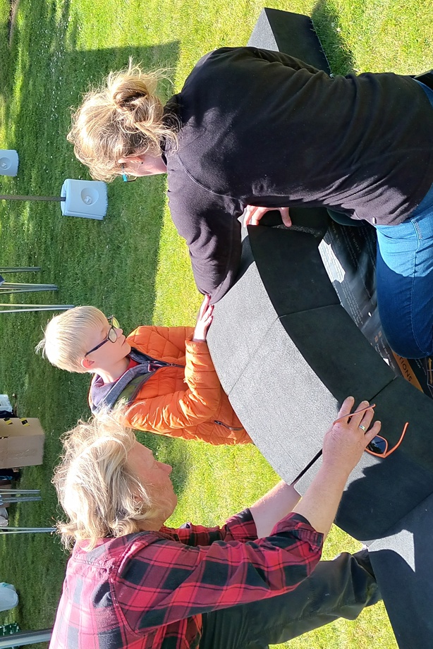 A young boy helps his mum and dad put the foam blocks together to complete the arch activity.