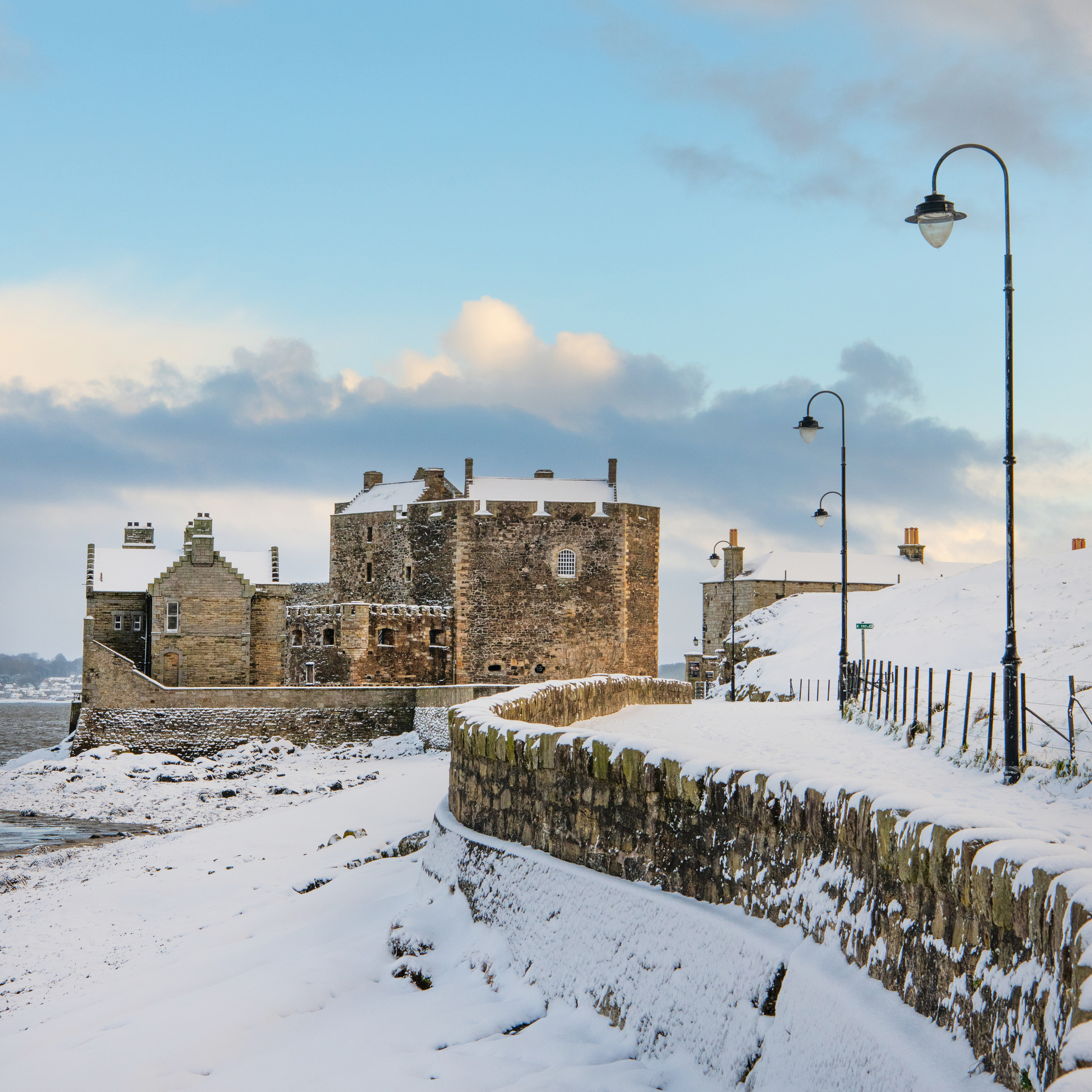A snow-covered road leading to a castle.