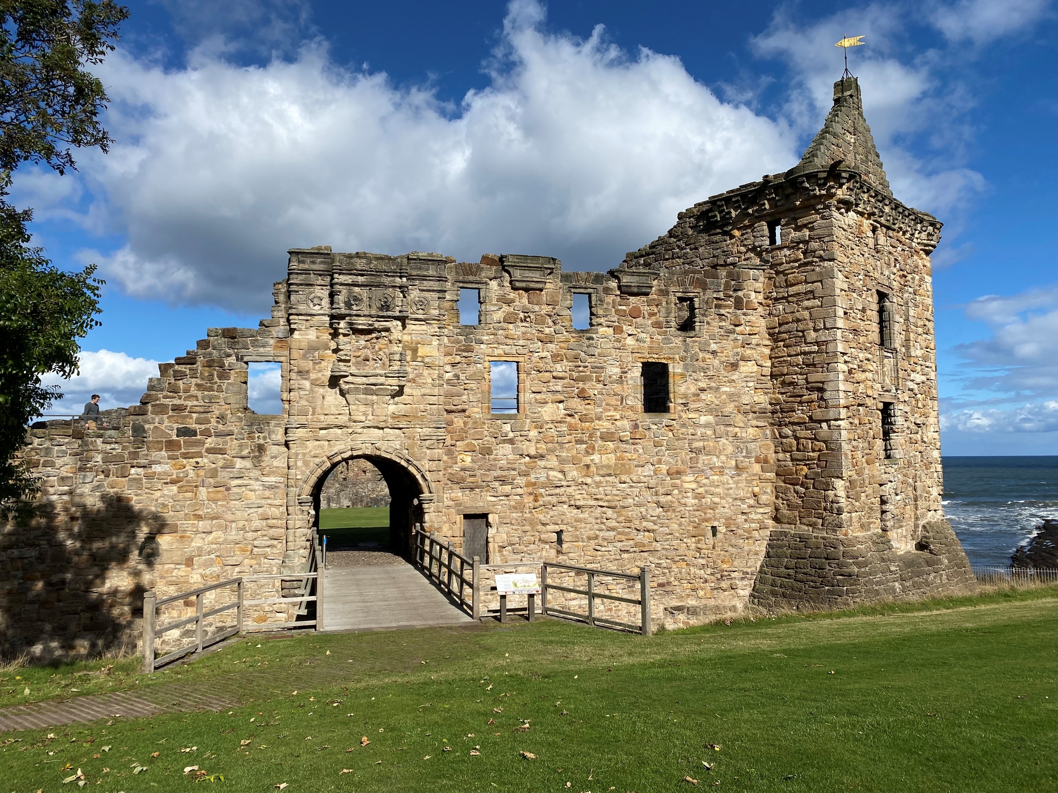 View of St Andrews Castle on a  bright, blue sky day with some clouds. 