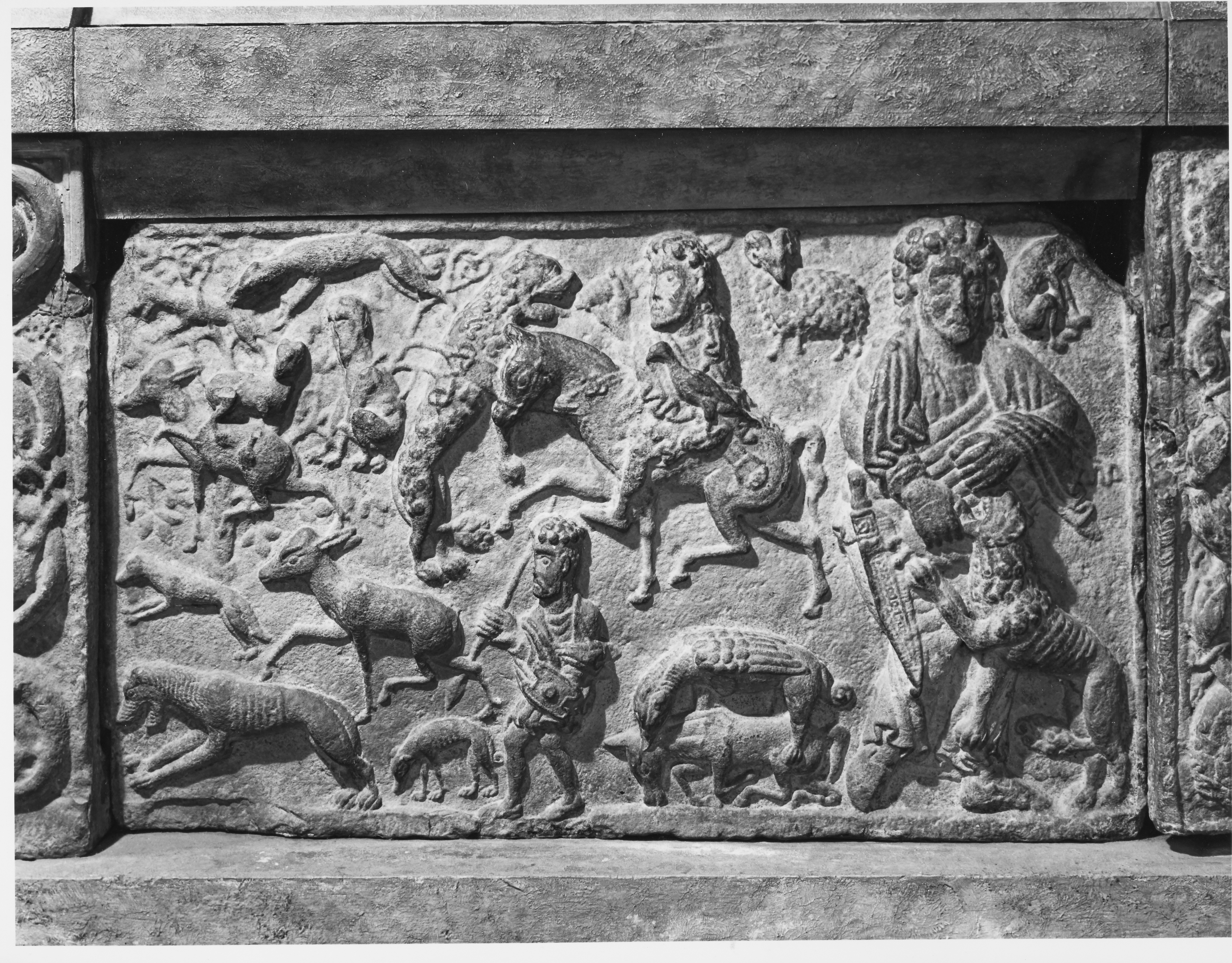 Engraved panel at St Andrews Cathedral showing a number of human figures and other creatures