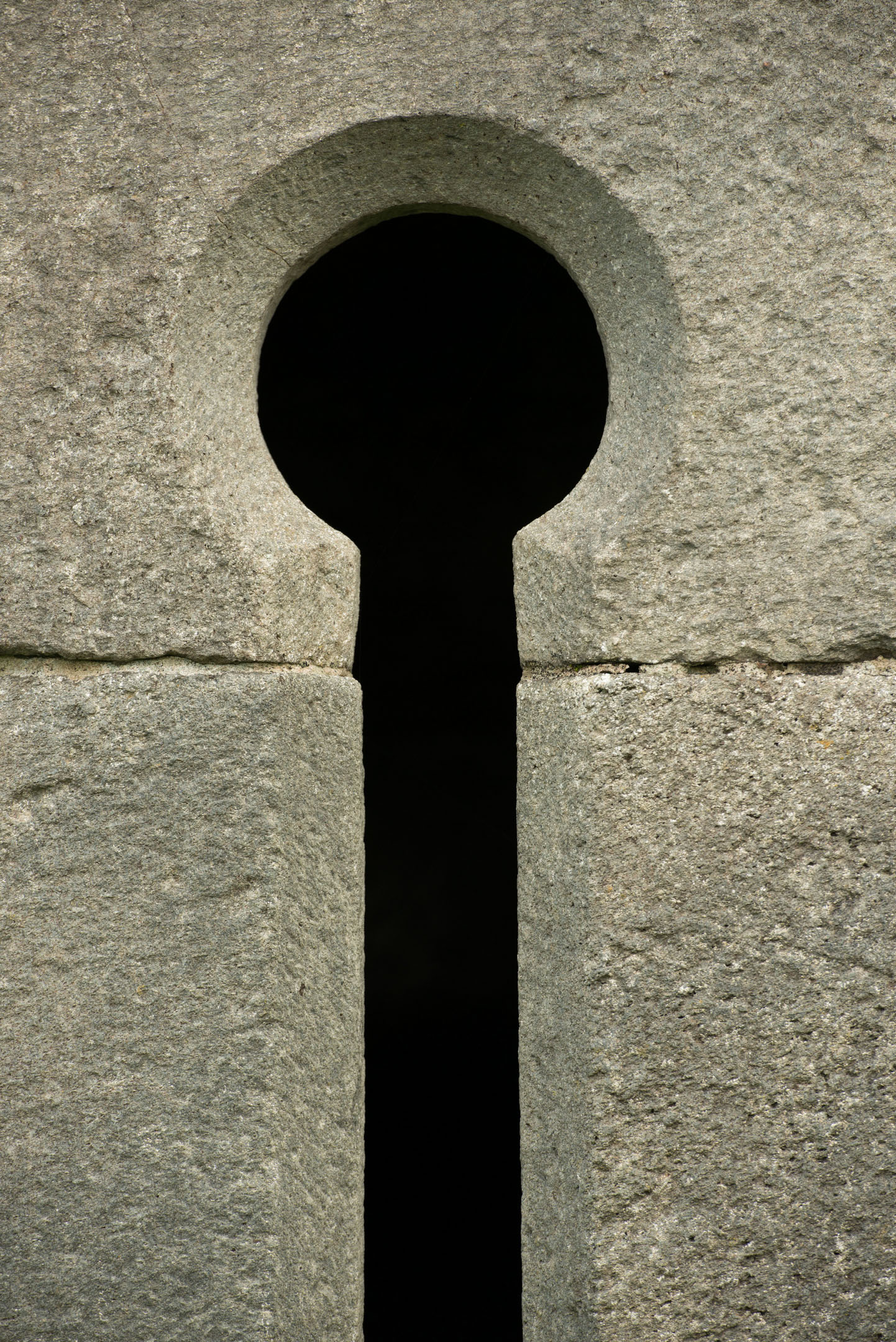 Close-up of stone keyhole-shaped opening in castle wall.
