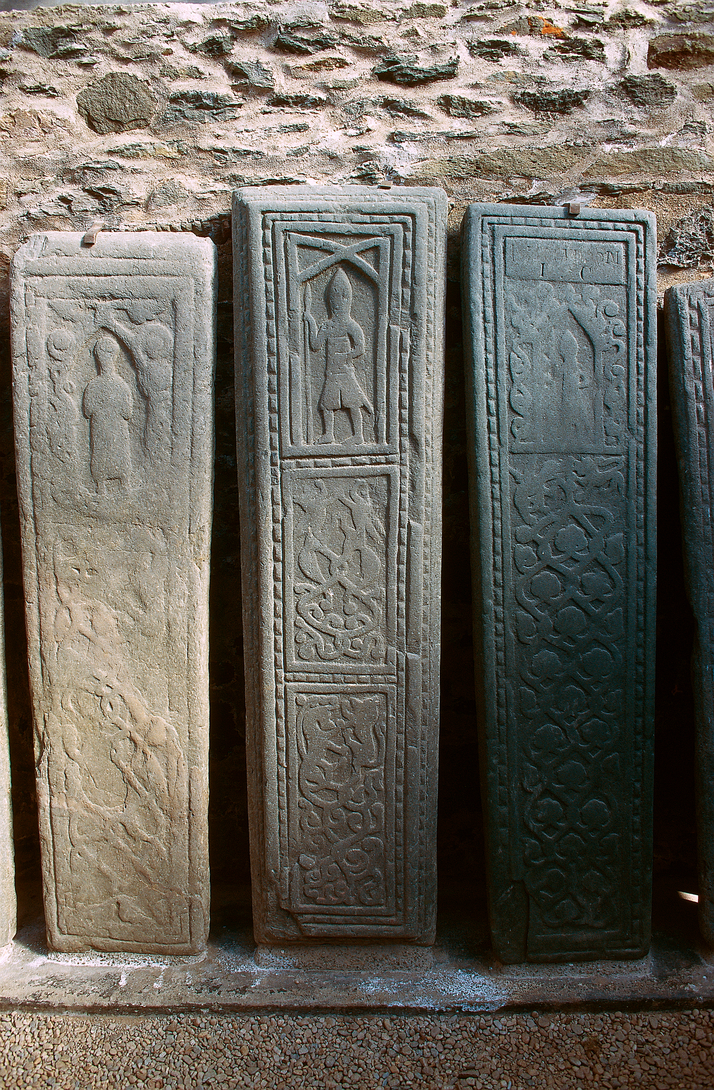 Close up of three carved stones with detailed rich carvings in full size. 