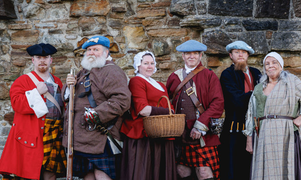 Six re-enactors in various historical costumes