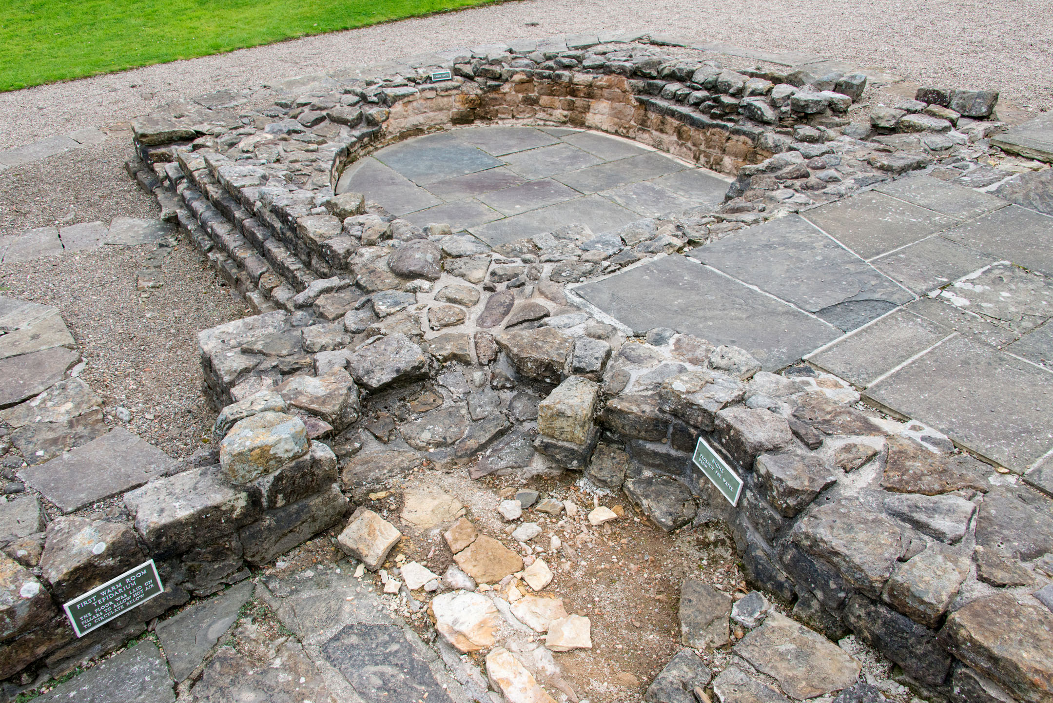 Circular stone bath structure remains at Bearsden Bath House.