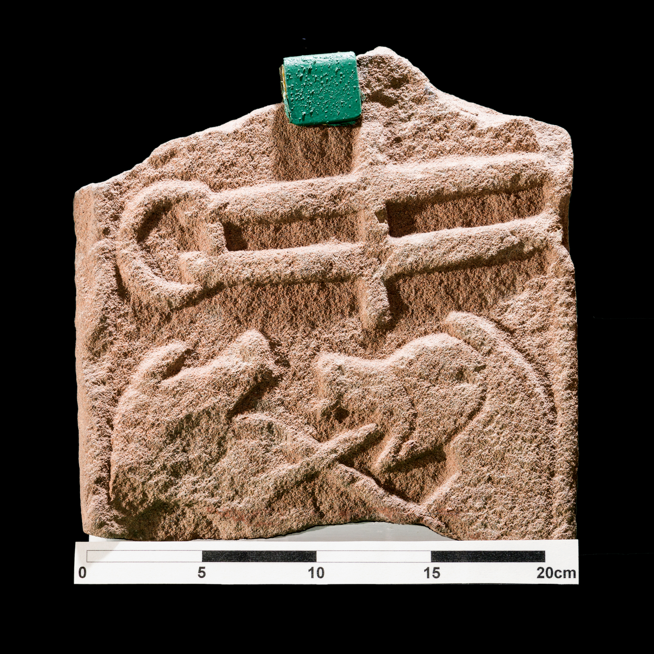 Sculptured stone, hard to make out details, possible animals fighting