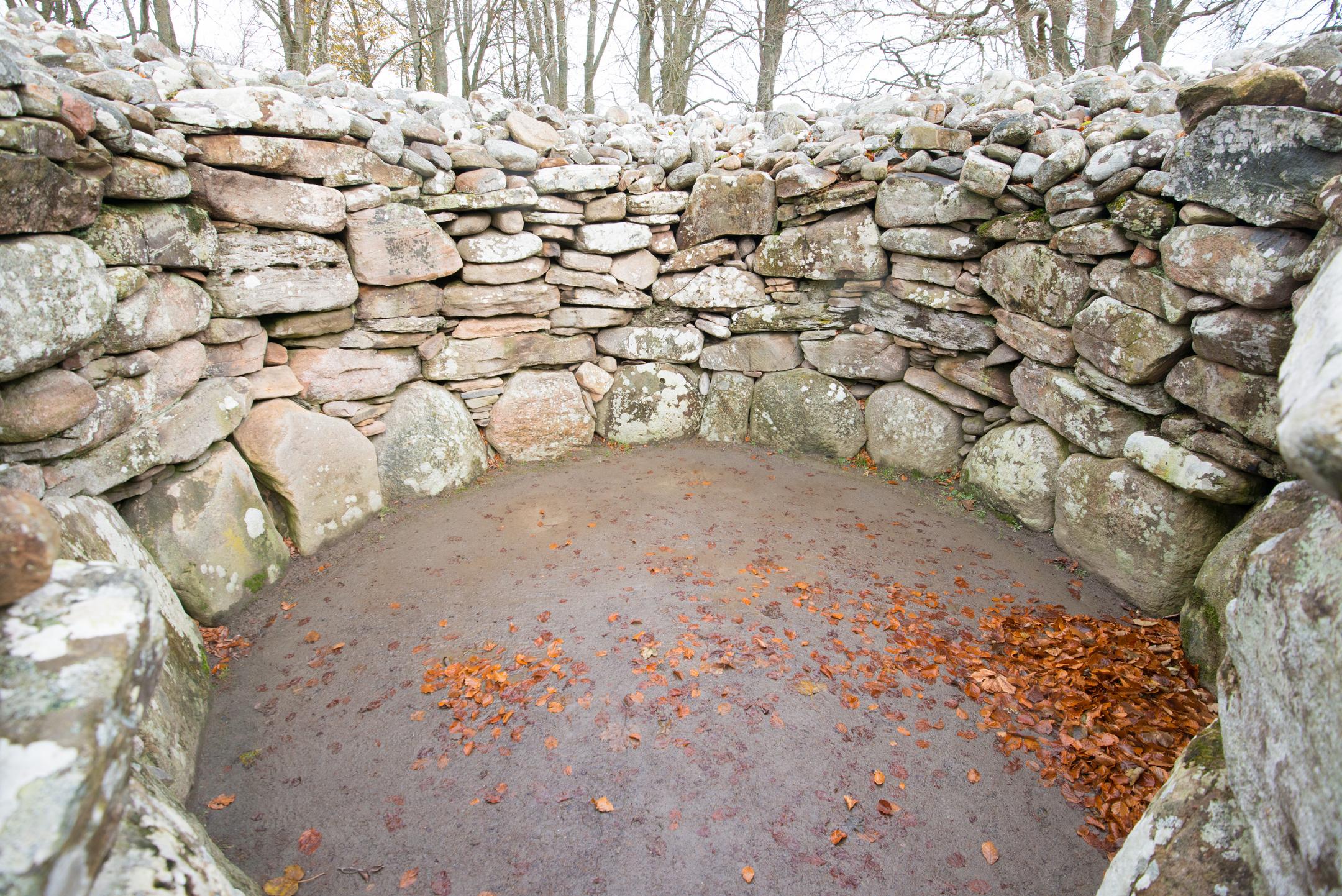 Inside a cairn, with autumn leaves