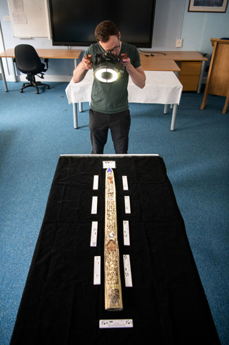 A person carrying out photogrammetry of the scabbard from The Honours of Scotland, displayed at Edinburgh Castle