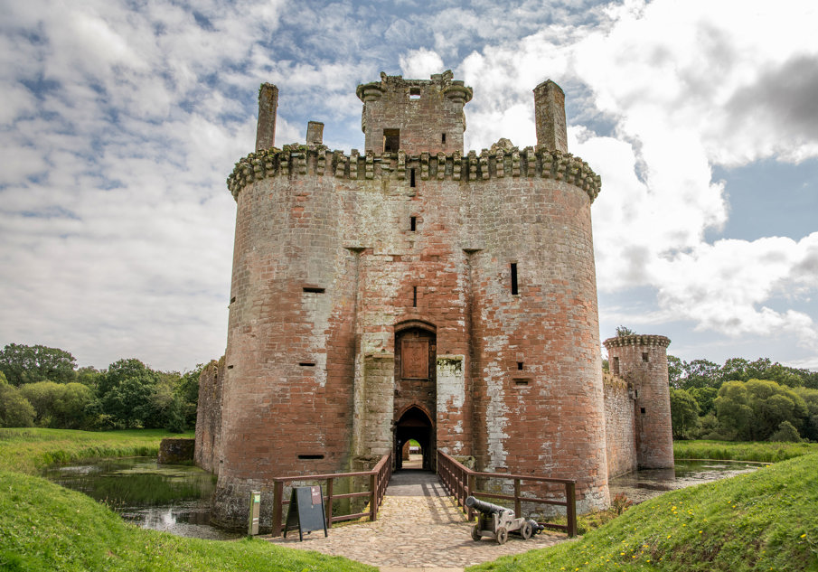 Exterior view of Caerlaverock Castle with blue skies above