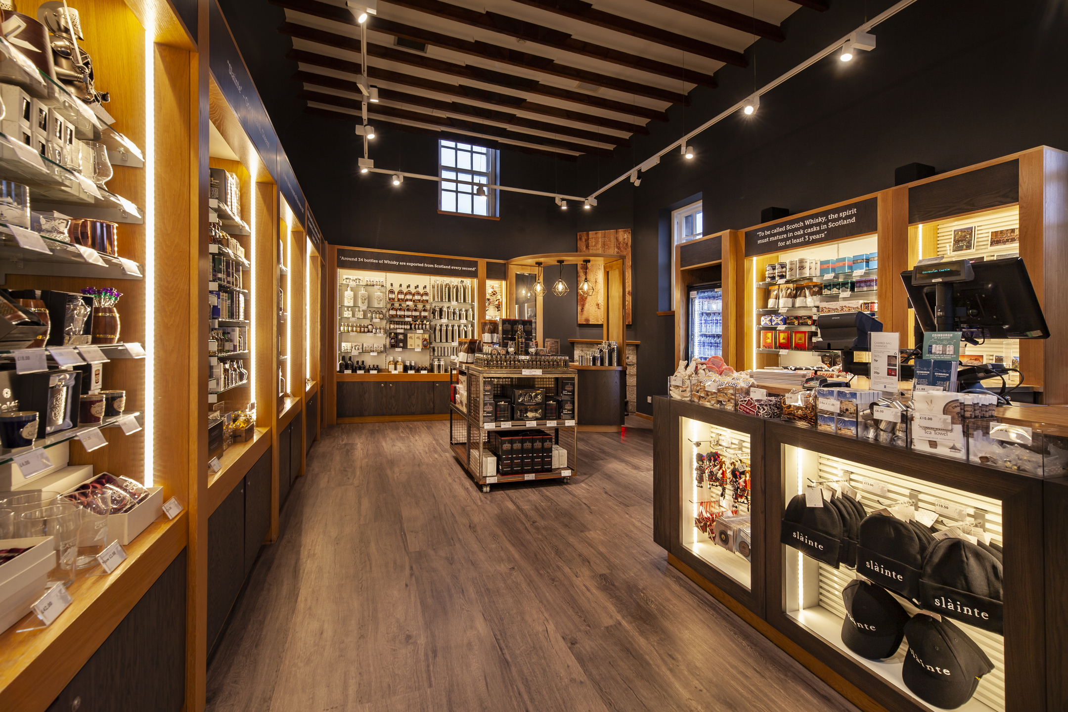 A well-stocked gift shop displaying a plethora of items including caps, mugs and high-quality foodstuffs.